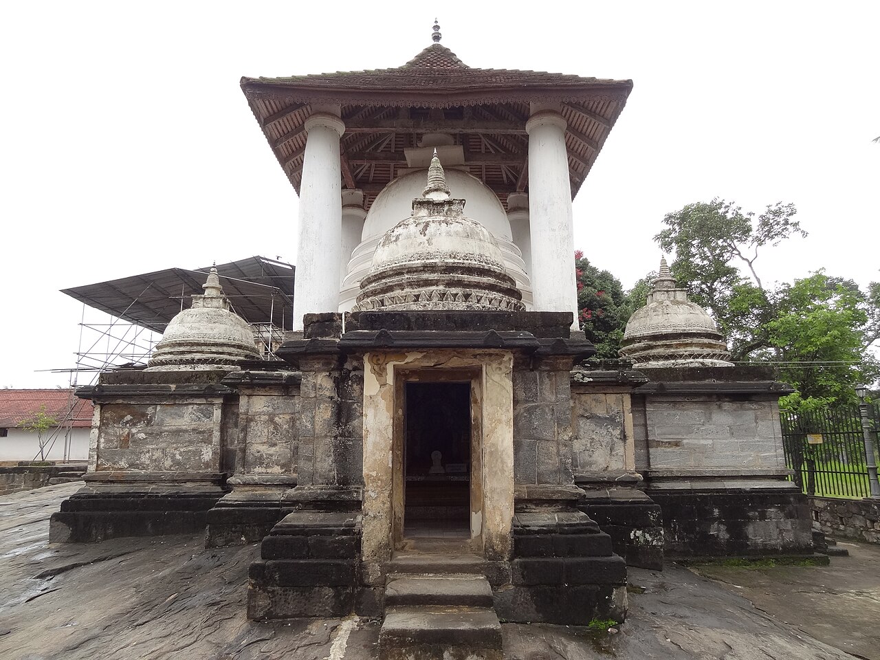 A quiet historic Kandyan monastic temple with white stupa near Kandy